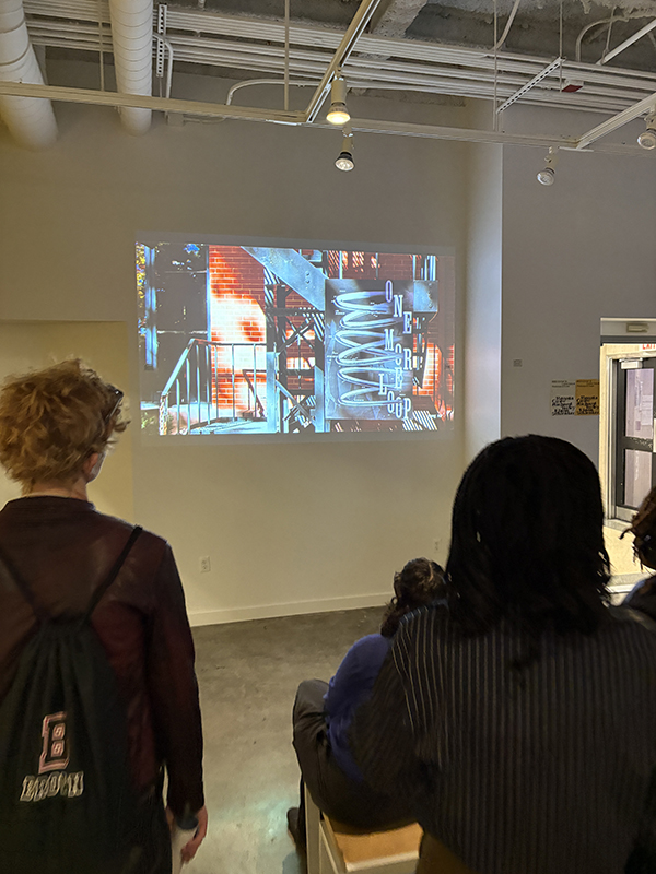 graphic design students looking at a projected poster in gd commons at RISD
